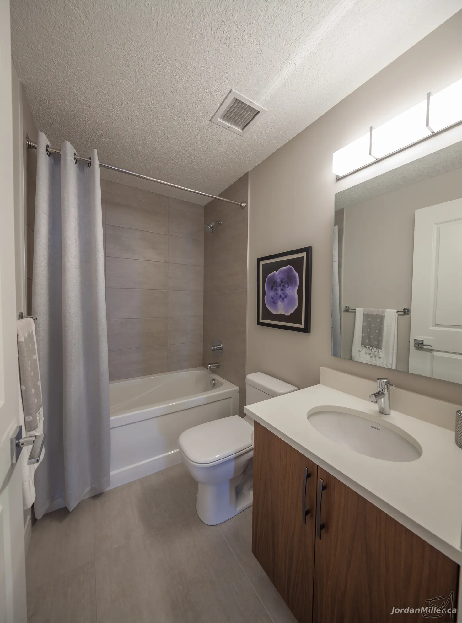 Second bathroom with tub and tile surround